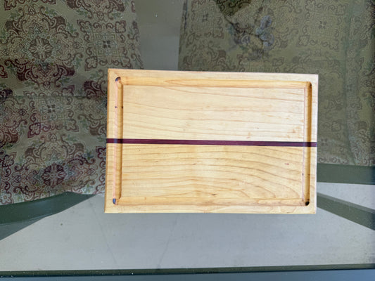 Wooden tray with a purple band on a patterned surface
